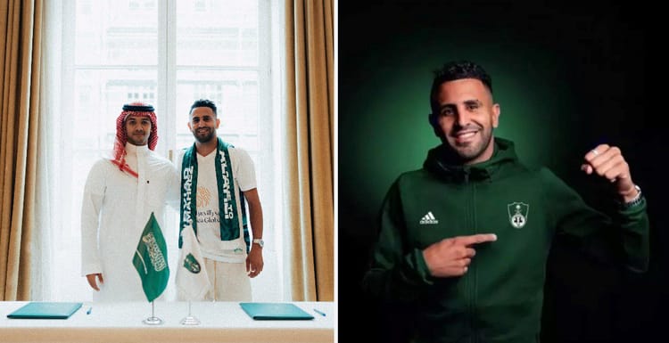 Riyad Mahrez en tenue de sport, souriant et montrant un signe de victoire.