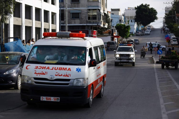 Ambulance de secours à Gaza, scène urbaine avec véhicules et passants.