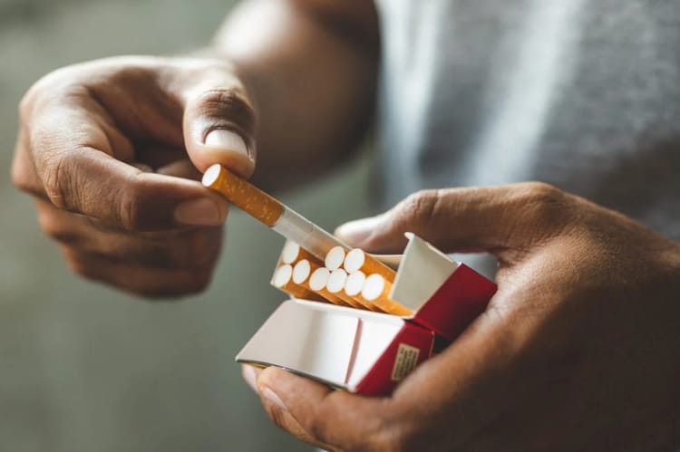 Les nouvelles règles sur le marché du tabac en Algérie à partir de 2025 Personne mettant des comprimés dans une boîte de médicaments ou de cigarettes.