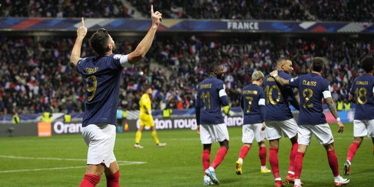 Équipe de France de football en célébration lors d'un match.