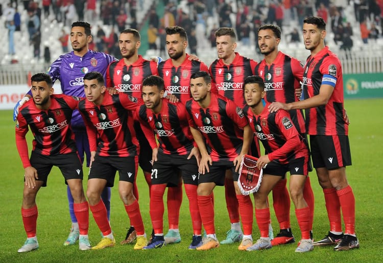 Quel entraineur pour l'USMA? L'équation à plusieurs inconnues qui hante les dirigeants du club Groupe de joueurs de football de l'USMA en tenue rouge et noire.