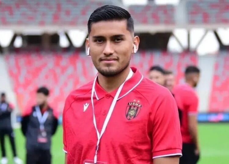 Adalid Terrazas expulsé en sélection : Quand la mauvaise nouvelle devient un avantage pour l'USM Alger Jeune joueur de football avec écouteurs, en tenue USM Alger, dans un stade.
