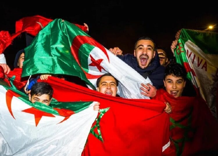 Jeunes algériens et marocains célébrant avec drapeaux nationaux.