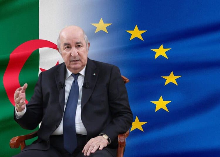 Algérie-UE : nouvelles avancées dans l'accord d'association Homme en costume devant les drapeaux d'Algérie et de l'Union européenne.