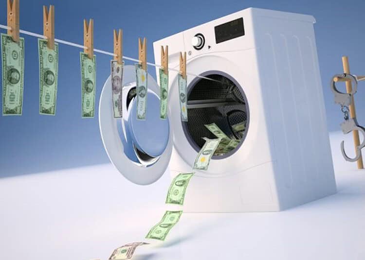 Algérie : Nouvelle vague de sanctions contre le blanchiment Machine à laver avec des billets de banque suspendus et sortant.